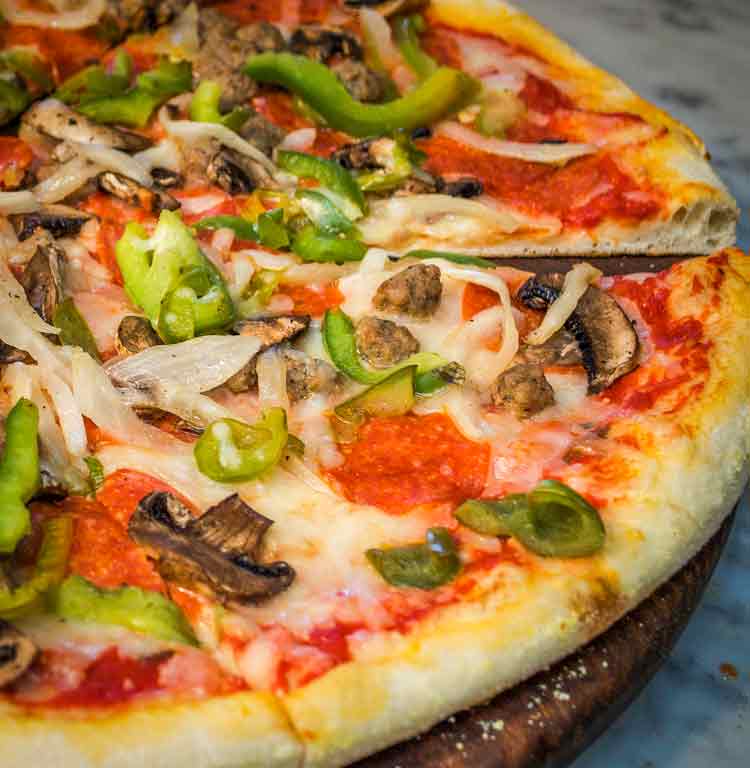 A pizza with mushroom and green chili